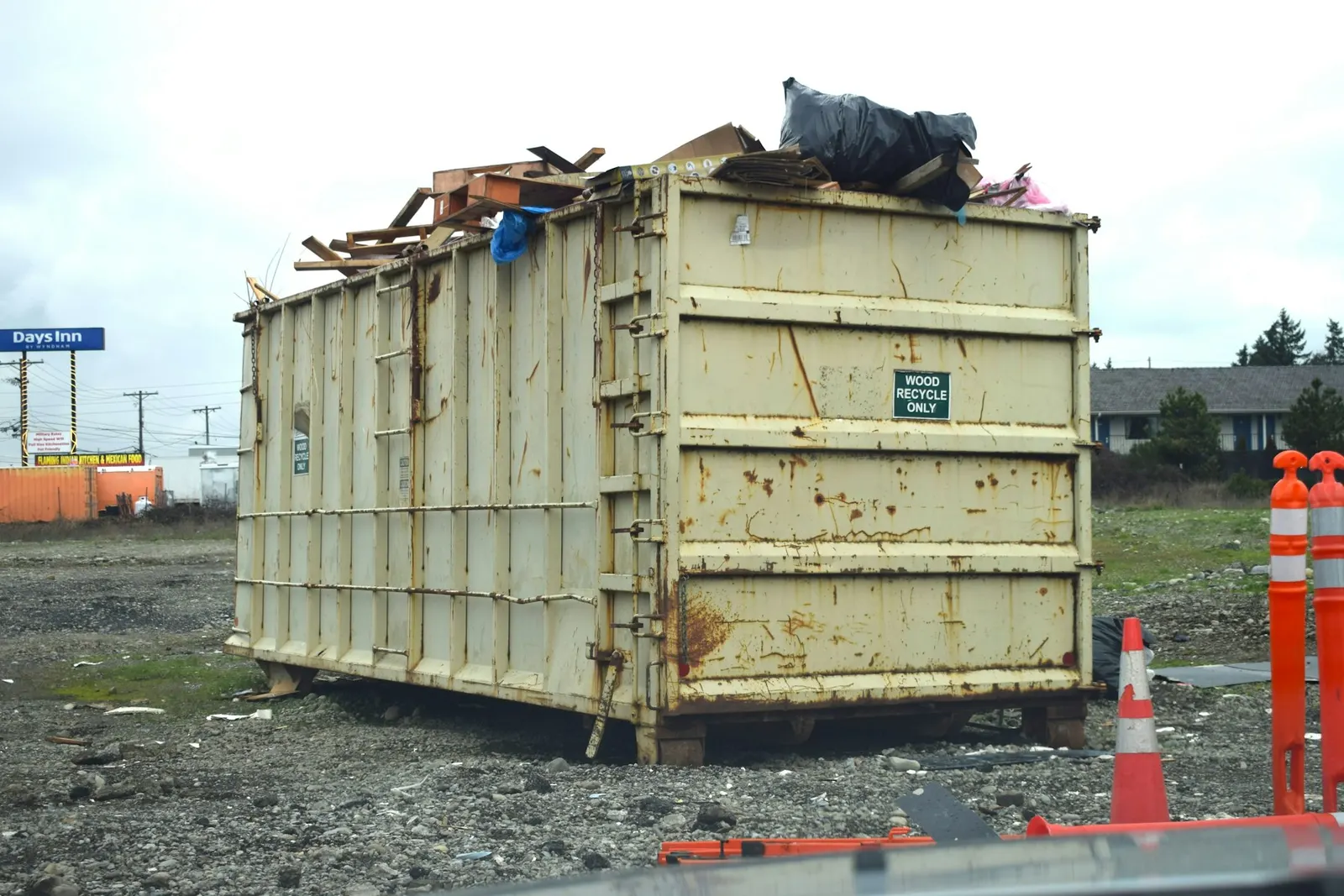 A large roll-off bin filled with debris