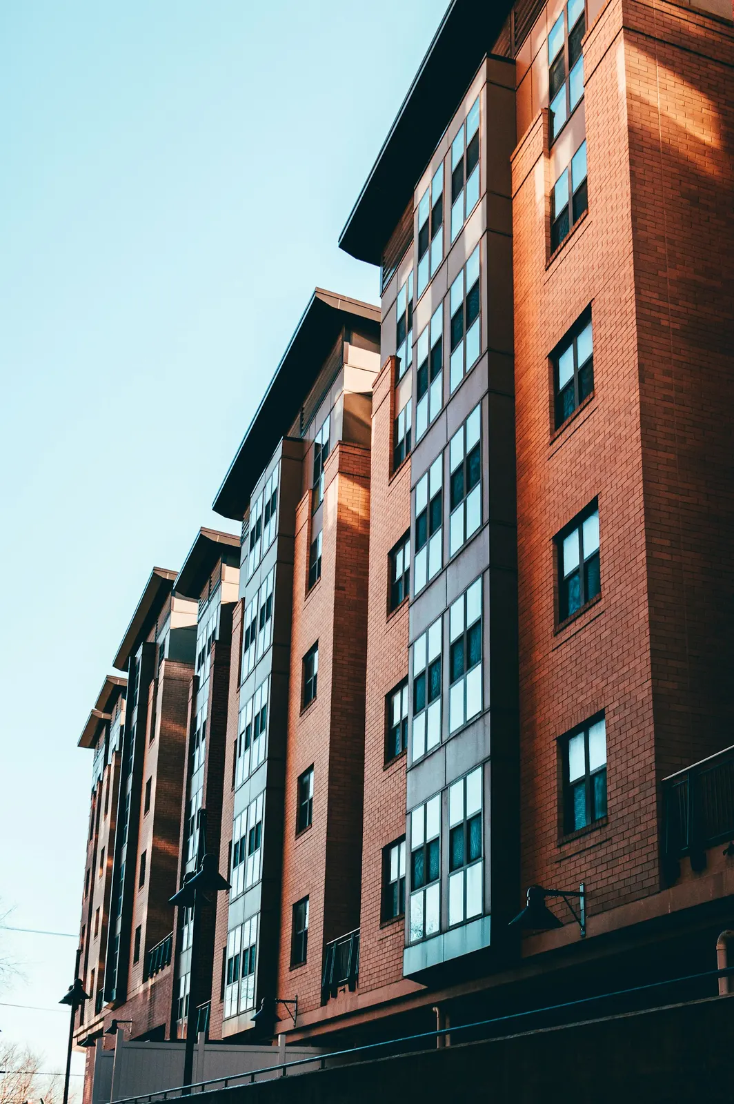 A brick apartment building with rows of windows