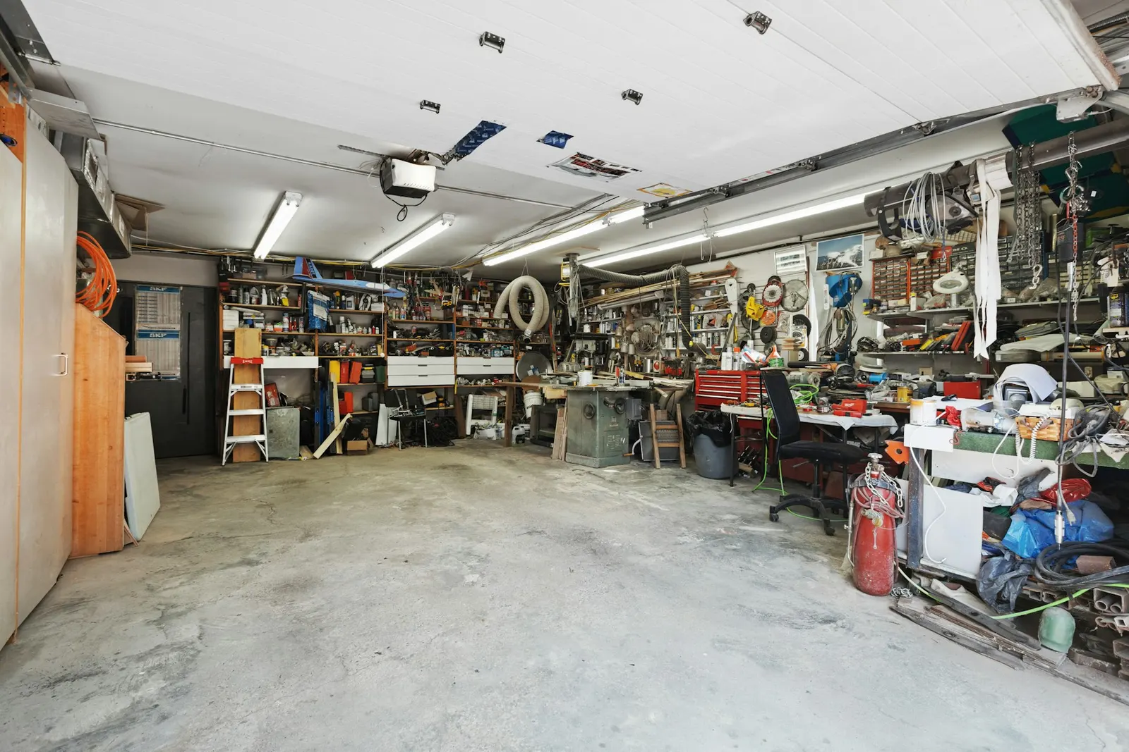 A garage full of tools, boxes and clutter