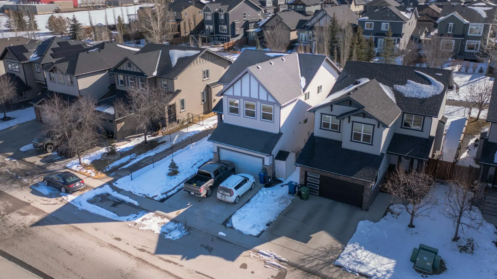 A snowy suburban street from above