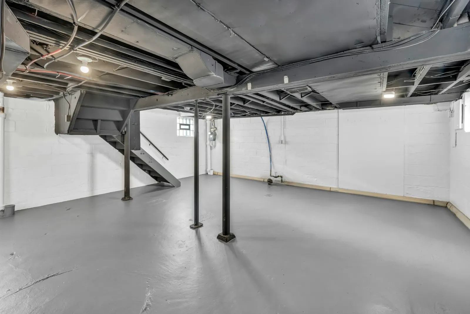 An unfinished basement with exposed joists